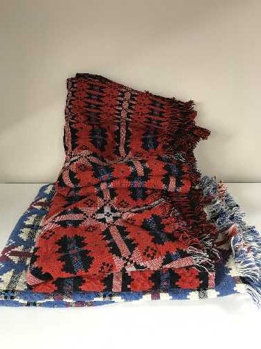 Three fringed woolen throws