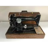 A mid 20th century oak cased Singer sewing machine