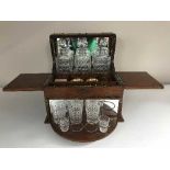 A Victorian oak three decanter tantalus and bridge box