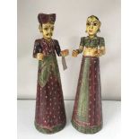 A pair of Indian hand painted wooden figures