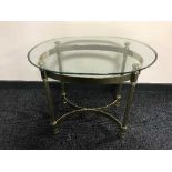 An oval brass glass topped lamp table