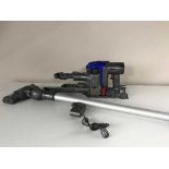 A Dyson DC35 multifloor hand held vac with attachments