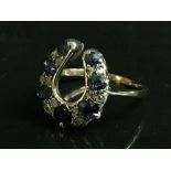 An antique horseshoe ring set with diamonds and sapphires