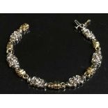 An 18ct yellow and white gold diamond set bracelet 18 grams, .