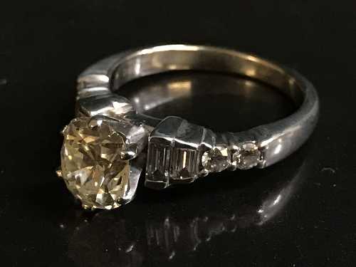 A large solitaire diamond ring in 18ct white gold, the cushion shaped old cut stone approximately 1.