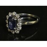 An 18ct white gold diamond sapphire cluster ring