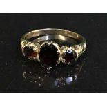 A 9ct gold three stone garnet ring