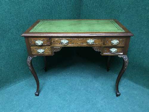 A mahogany lady's desk with tooled leather top