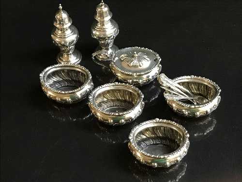 A seven piece silver cruet set by Walker & Hall, Sheffield 1901, with five matching spoons, 11.