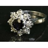 An 18ct white gold diamond and sapphire cluster ring