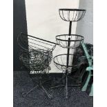 A metal garden three tier stand with hanging baskets