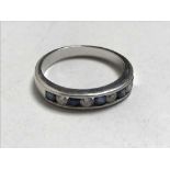 An 18ct white gold diamond and sapphire half eternity ring