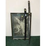 An antique samurai sword in scabbard and a monochrome print of an angel