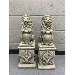 A garden figure - pair of lions on plinths