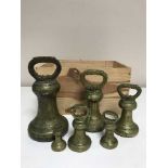 A set of six antique brass graduated weights