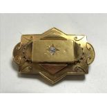 A very large 15ct gold diamond set brooch, 17.3g, central stone approximately 0.3ct.