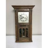 An Edwardian oak wall clock with calenderer dial