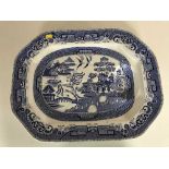 A 19th century blue and white willow pattern meat plate