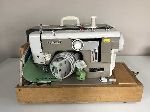 A New Home electric sewing machine and one other