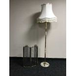 A four way brass folding spark guard and a brass & marble standard lamp