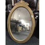 An early 20th century painted oval framed mirror