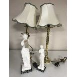 A pair of classical style figures and a pair of table lamps