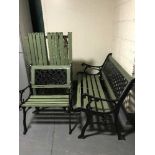 A wrought iron and wooden three piece patio set