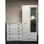 A white compactum wardrobe and four drawer chest