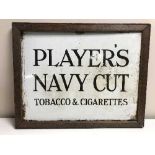 An oak framed Players Navy Cut Tobacco & Cigarette enamel advertisement