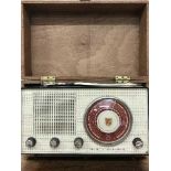 A deed box containing an old radio