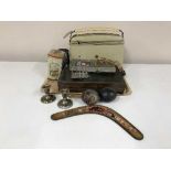 A tray of Bush radio, maracas, boomerang, canteen of cutlery,