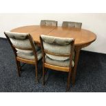 A late 20th century teak extending dining table and four chairs