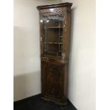 A mahogany glazed door corner cabinet