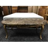 A gilt wood oval coffee table with marble top