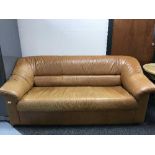 A brown leather three seater settee