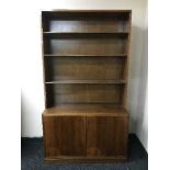 A set of mahogany open shelves fitted a cupboard