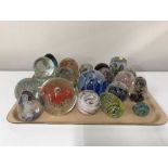 A tray of twenty one assorted glass paperweights