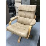 A leather adjustable swivel armchair