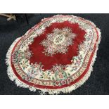 A Chinese oval embossed floral rug