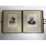 An antique leather bound photo album of monochrome photos