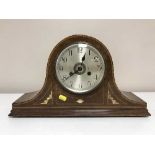 An inlaid mahogany mantel clock with silvered dial