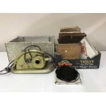 A boxed Gem projector and a box of film reels,