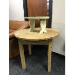 A rustic pine table and a small painted stool