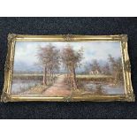 A large gilt framed oil on canvas - path through rural landscape signed I.