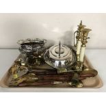 A tray of plated entree dish, bowl, brass candle holders, napkin rings,