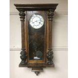 A mahogany wall clock with enamel dial