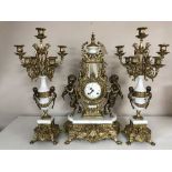 An ornate gilt three-piece clock garniture.