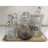 A tray of six assorted lead crystal decanters with stoppers