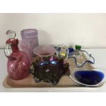 A tray of cranberry glass decanter with stopper, carnival glass, assorted glass vases, bowls,