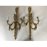 A pair of gilt metal three way wall sconces